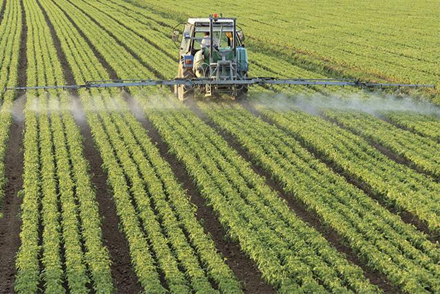Tractor Spraying Chemicals On a Field